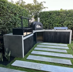 An outdoor kitchen installation with custom pavers