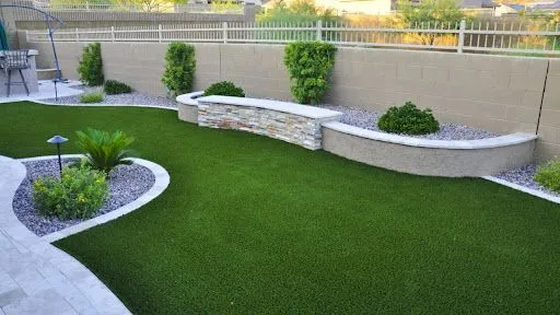 Artificial turf installed in a backyard covered in shade
